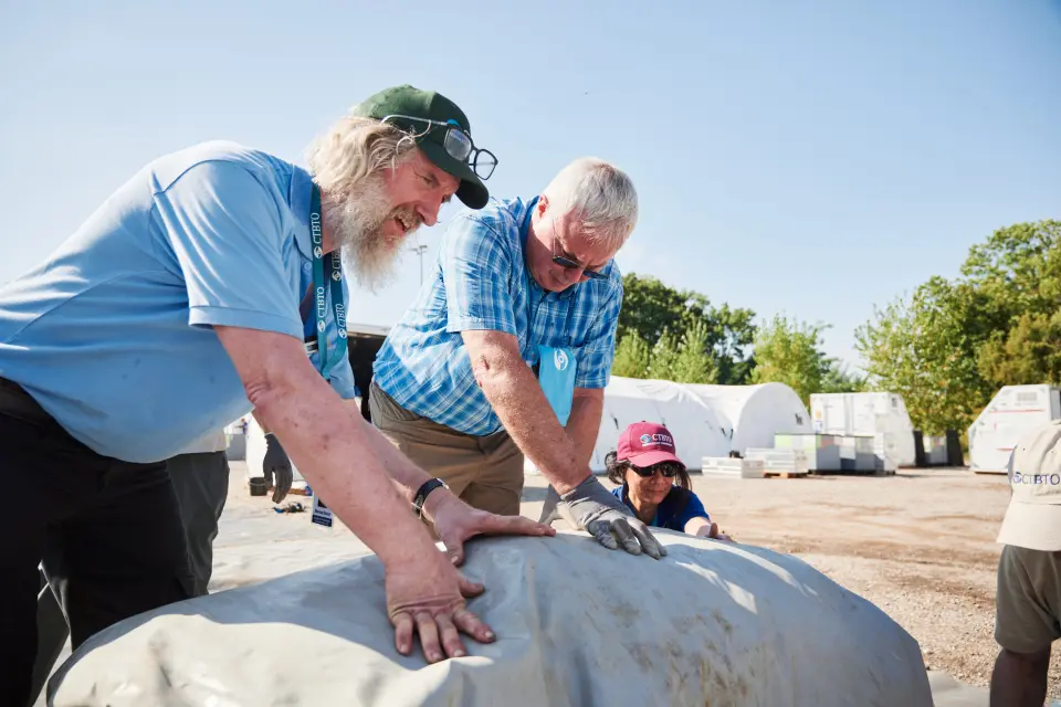 Morten Sickel packing up a tent base together with fellow inspectors from the Netherlands and Thailand under an exercise. Photo: CTBTO